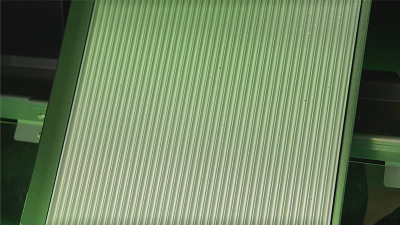 The chute through which the rice flows, inside the rice color sorter.