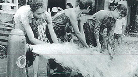 Women in Phnom Penh drawing water from a public hydrant